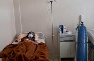 A COVID-19 patient lies in a hospital bed at Dr. Suyoto General Hospital in Jakarta, Indonesia, a country suffering from a devastating wave of coronavirus cases, fueled by the virulent delta variant first detected in India.  (AP Photo / Tatan Syuflana)