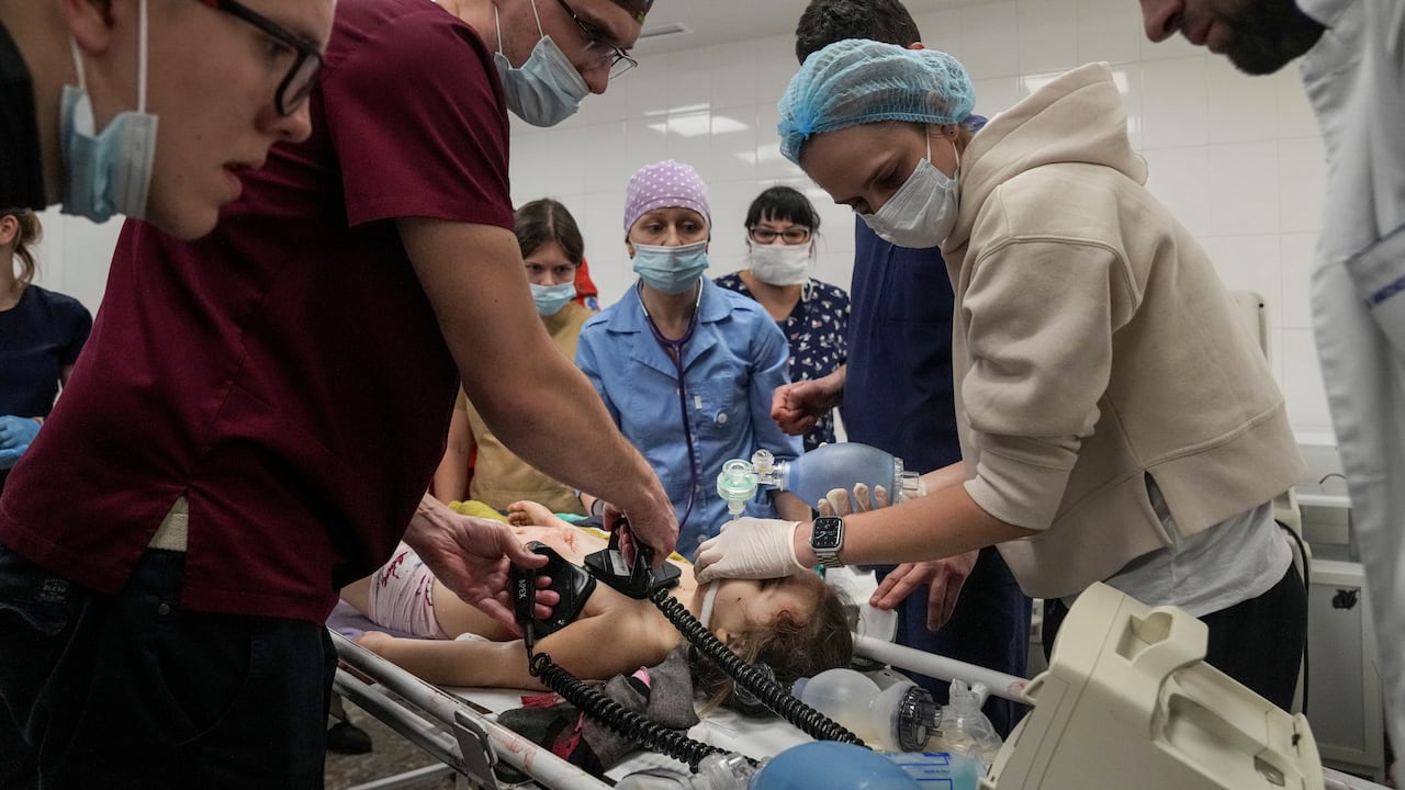 Medics perform CPR on a girl injured during the shelling of a residential area, in the city hospital of Mariupol, eastern Ukraine, Sunday, Feb. 27, 2022. The girl did not survive. (AP Photo/Evgeniy Maloletka)