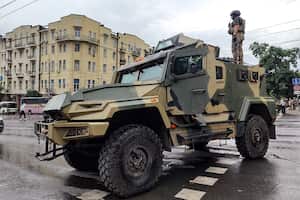 A serviceman stands atop of an armored vehicle of the Wagner Group military company, as he guards an area at the HQ of the Southern Military District in a street in Rostov-on-Don, Russia, Saturday, June 24, 2023. Russia's security services had responded to Prigozhin's declaration of an armed rebellion by calling for his arrest. In a sign of how seriously the Kremlin took the threat, security was heightened in Moscow, Rostov-on-Don and other regions. (AP Photo)
