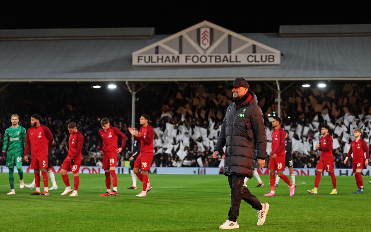Liverpool's German manager Jurgen Klopp leaves the pitch as the players line up ahead of the English League Cup demi-final second leg football match between Fulham and Liverpool at Craven Cottage stadium, in London, on January 24, 2024. (Photo by Adrian DENNIS / AFP) / RESTRICTED TO EDITORIAL USE. No use with unauthorized audio, video, data, fixture lists, club/league logos or 'live' services. Online in-match use limited to 120 images. An additional 40 images may be used in extra time. No video emulation. Social media in-match use limited to 120 images. An additional 40 images may be used in extra time. No use in betting publications, games or single club/league/player publications. /