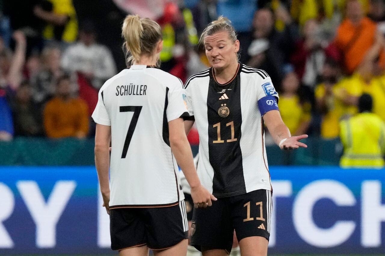 Germany's Alexandra Popp, center, gestures to teammate Lea Schueller while Colombia players celebrate at the end of the Women's World Cup Group H soccer match between Germany and Colombia at the Sydney Football Stadium in Sydney, Australia, Sunday, July 30, 2023. Colombia won 2-1. (AP Photo/Mark Baker)