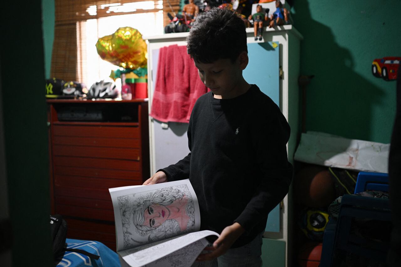 El estudiante venezolano Randy Ordóñez muestra sus cuadernos durante una entrevista con la AFP.