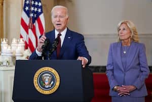 U.S. President Joe Biden is accompanied by first lady Jill Biden and flanked by a display of candles with names of those who died in the school shooting at Robb Elementary School in Uvalde, Texas, as he speaks during an event to mark the first anniversary of Uvalde at the White House in Washington, U.S., May 24, 2023. REUTERS/Kevin Lamarque  