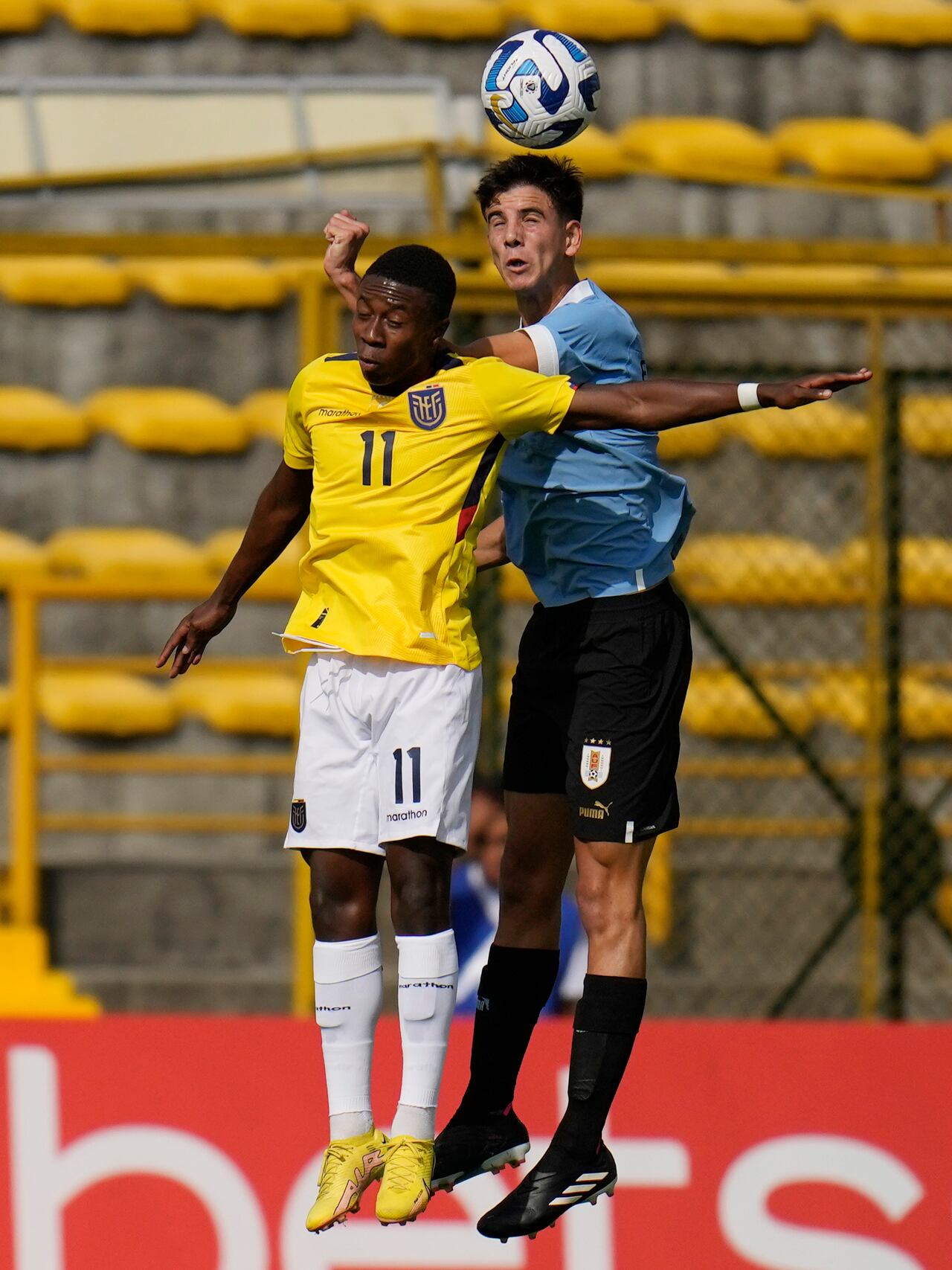 Ecuador's Alan Minda, left, and Uruguay's Facundo Gonzalez go for a header during a South America U-20 soccer match in Bogota, Colombia, Friday, Feb. 3, 2023. (AP Photo/Fernando Vergara)