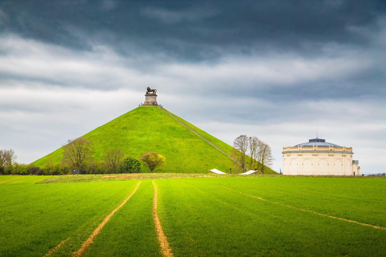 Panorama view of famous Lion's Mound (Butte du Lion) memorial site, a conical artificial hill located in the municipality of Braine-l'Alleud comemmorating the battle of Waterloo, on a moody day with dark clouds in summer, Belgium