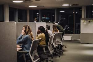 Multiracial team working side by side in illuminated call center