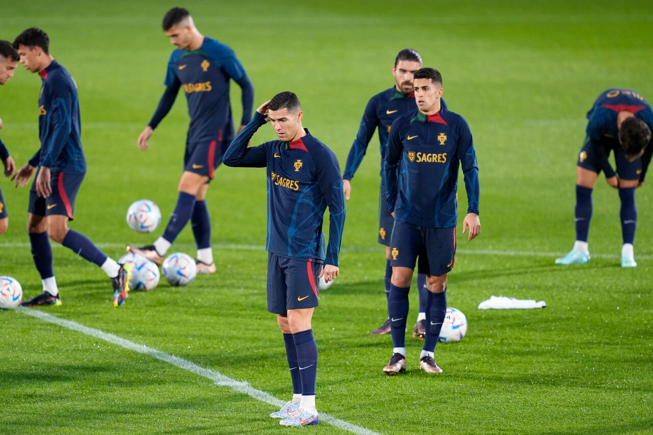 Cristiano Ronaldo, center, scratches his head during a Portugal soccer team training in Oeiras, outside Lisbon, Monday, Nov. 14, 2022. Portugal will play Nigeria Thursday in a friendly match in Lisbon before departing to Qatar on Friday for the World Cup. (AP Photo/Armando Franca)