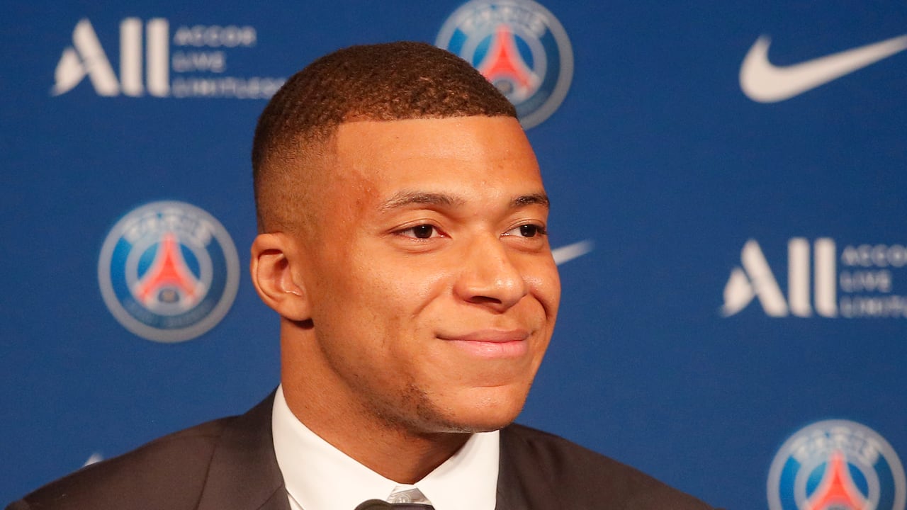 PSG striker Kylian Mbappe smiles during a press conference Monday, May 23, 2022 at the Paris des Princes stadium in Paris. Kylian Mbappé's decision to reject Real Madrid and commit to Paris Saint-Germain for three more seasons marks the start of a large rebuilding project at the French league champion. (AP Photo/Michel Spingler)