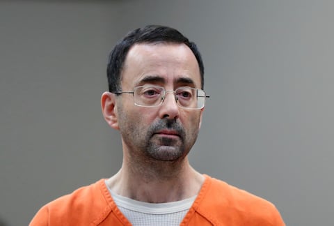 FILE - In this Nov. 22, 2017 file photo, Dr. Larry Nassar appears in court for a plea hearing in Lansing, Mich. Long sought sexual assault measures in Michigan first introduced in the wake of the Larry Nassar scandal will soon be implemented after Michigan Gov. Gretchen Whitmer signed legislation Thursday, June 29, 2023. The package will create stricter punishments for sexual assault under the guise of medical treatment and protect students who report it. It will also require the creation and distribution of comprehensive training materials for people required to report suspected child abuse and neglect. (AP Photo/Paul Sancya, File)