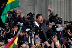 El presidente boliviano Luis Arce levanta un puño cerrado rodeado de partidarios y medios de comunicación frente al palacio de gobierno en La Paz, Bolivia, el miércoles 26 de junio de 2024. (AP Foto/Juan Karita)