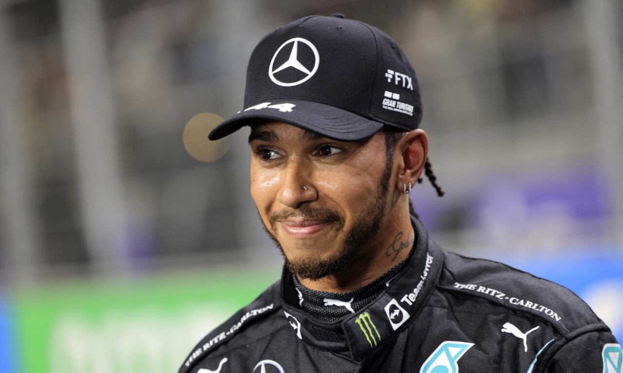 FILE- Mercedes driver Lewis Hamilton, of Britain smiles, after winning the pole position during qualifying for the Formula One Saudi Arabian Grand Prix auto race on Dec. 4, 2021, in Jiddah, Saudi Arabia. Hamilton returned to social media Saturday, Feb. 5, 2022, following a lengthy silence that dates to last season's controversial Formula 1 finale. (AP/Giuseppe Cacace/Pool)