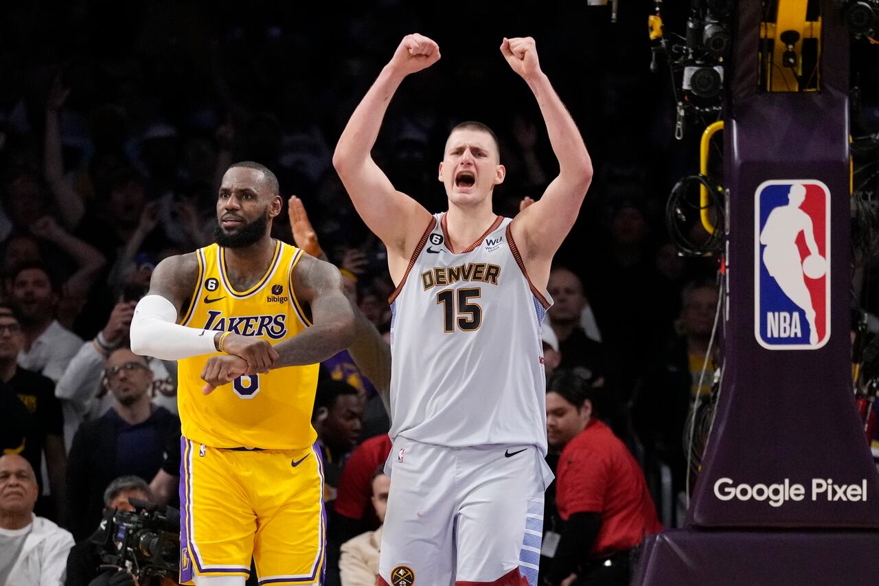 Denver Nuggets center Nikola Jokic (15) celebrates after Los Angeles Lakers forward LeBron James, left, missed a layup attempt as time expired in the second half of Game 4 of the NBA basketball Western Conference Final series Monday, May 22, 2023, in Los Angeles. Denver won 113-111 to win the series. (AP Photo/Ashley Landis)