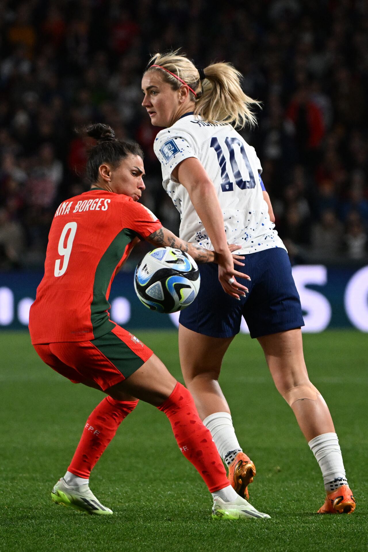 USA's midfielder #10 Lindsey Horan (R) fights for the ball with Portugal's forward #09 Ana Borges (L) during the Australia and New Zealand 2023 Women's World Cup Group E football match between Portugal and the United States at Eden Park in Auckland on August 1, 2023. (Photo by Saeed KHAN / AFP)