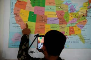 Un migrante venezolano que busca asilo mira un mapa de los Estados Unidos después de llegar al Centro de Bienvenida a Migrantes administrado por la ciudad de El Paso y la Oficina de Manejo de Emergencias, en El Paso, Texas, EE. UU., 3 de octubre de 2022. 