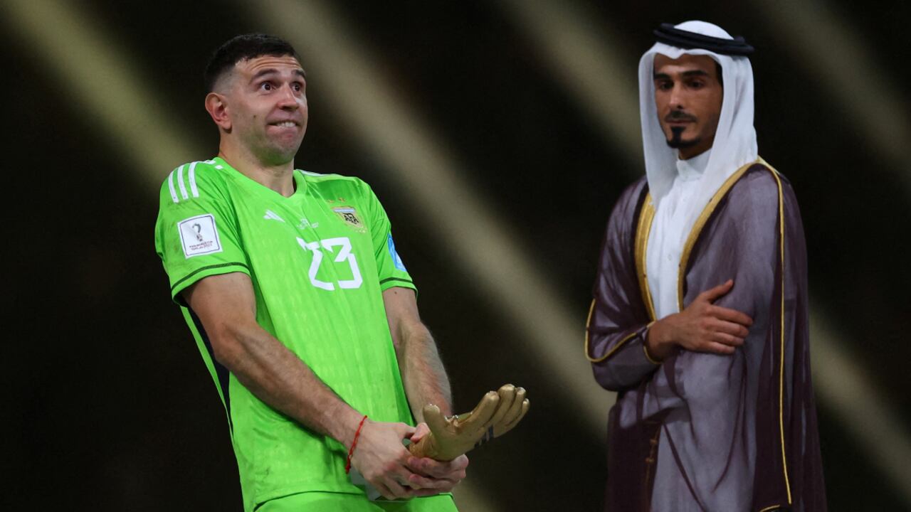 Soccer Football - FIFA World Cup Qatar 2022 - Final - Argentina v France - Lusail Stadium, Lusail, Qatar - December 18, 2022 Argentina's Emiliano Martinez reacts after receiving the Golden Glove award after the match REUTERS/Kai Pfaffenbach TPX IMAGES OF THE DAY