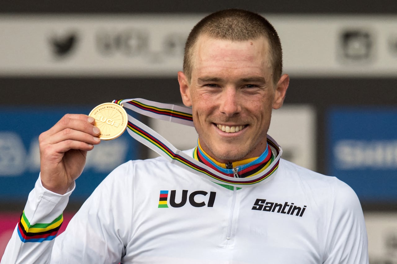 (FILES) This photo taken on September 25, 2019 shows Australian cyclist Rohan Dennis celebrating on the podium after winning  the Elite Men Individual Time Trial at the 2019 UCI Road World Championships in Harrogate, northern England. Former world champion cyclist Rohan Dennis has been charged over the death of his Olympian wife, Australian media reported on January 1, 2024, after allegedly hitting her with a car. (Photo by Oli SCARFF / AFP)