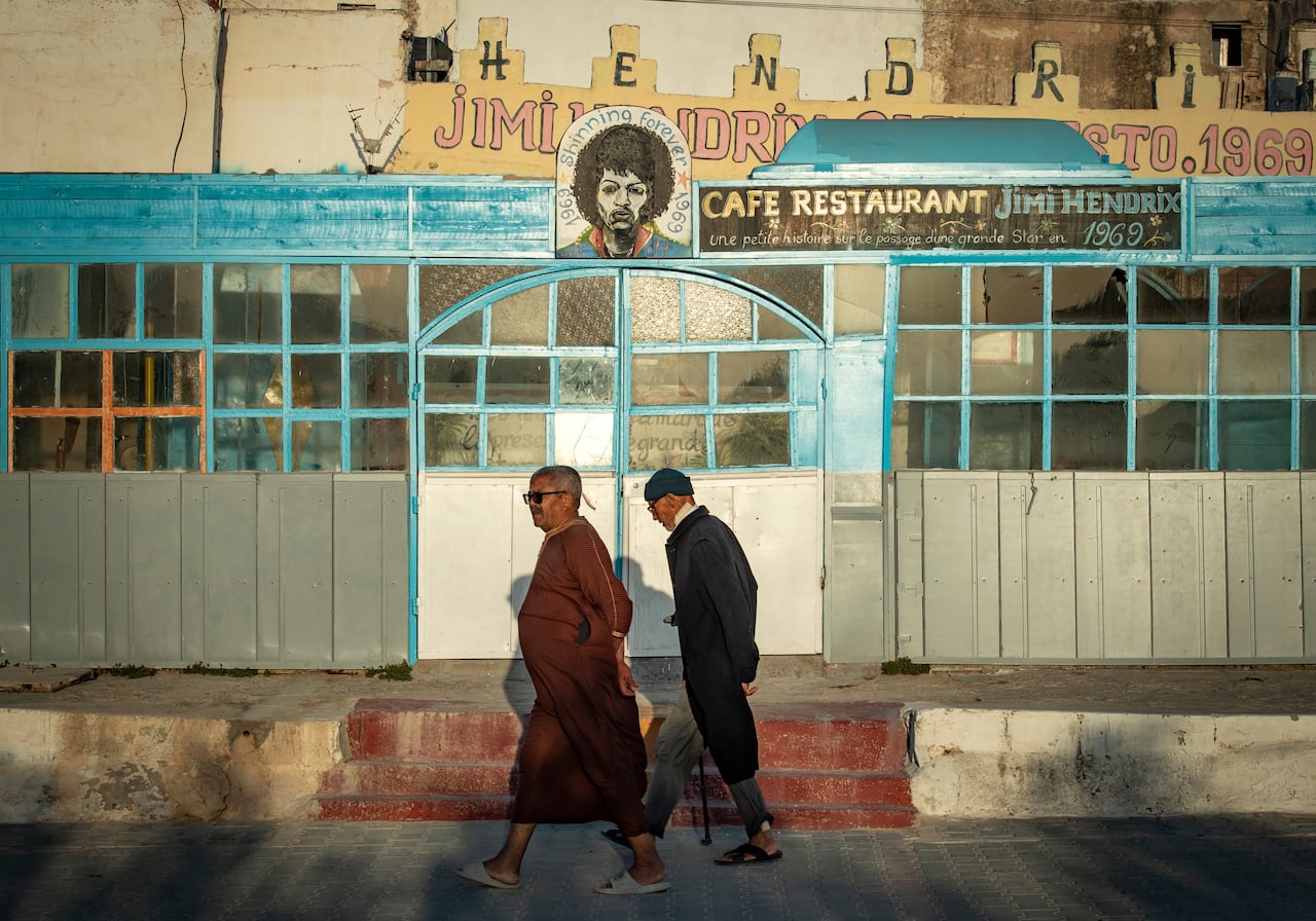 A picture taken in the Moroccan coastal city of Essaouira shows portraits of late US guitarist Jimi Hendrix on September 10, 2020. - Some claim to have seen him, others to have spoken with him -- 50 years after guitar legend Jimi Hendrix's untimely death, a village on Morocco's Atlantic coast pulsates with his memory. In the Summer of 1969, Hendrix, the pioneering US guitar wizard whose whose hits included "Purple Haze" and "Hey Joe", made a brief stop in Essaouira, a former fort town and latter day tourist magnet located five kilometres (three miles) from his childhood village. (Photo by FADEL SENNA / AFP)