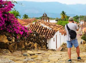 A traveller stopping to take a photograph the beautiful village of Guane, that is reached by taking the historic "Camino Real", a stone path about a two hour walk from the town of Barichara. The road, built by the indigenous Guane,has been declared a national monument.