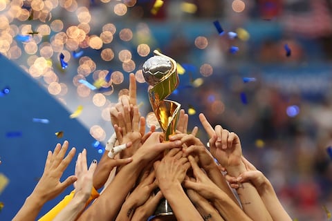ILE - In this July 7, 2019, file photo, the United States players hold the trophy as they celebrate winning the Women's World Cup final soccer match against The Netherlands at the Stade de Lyon in Decines, outside Lyon, France. The 2023 Women's World Cup will be spread across nine cities in Australia and New Zealand. (AP Photo/Francisco Seco, File)
