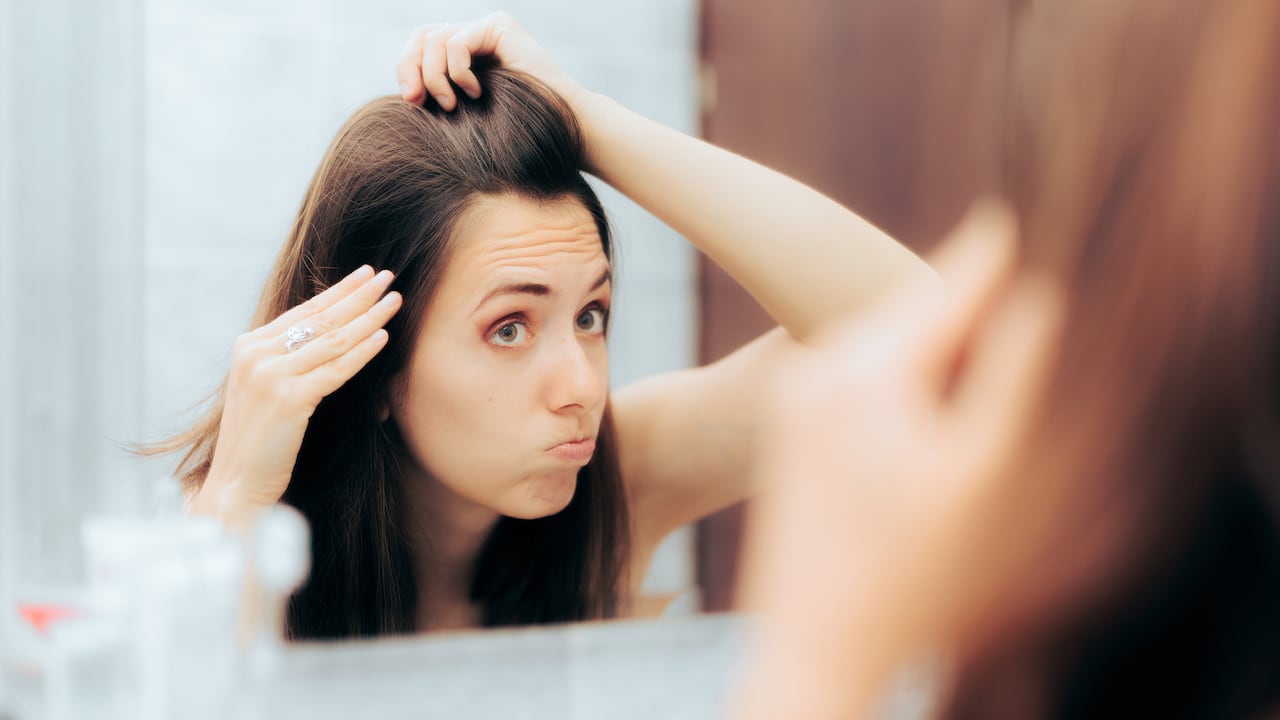 Person aging prematurely looking in the mirror