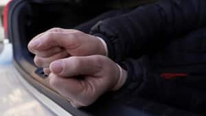 the bound hands of the person lying in the trunk