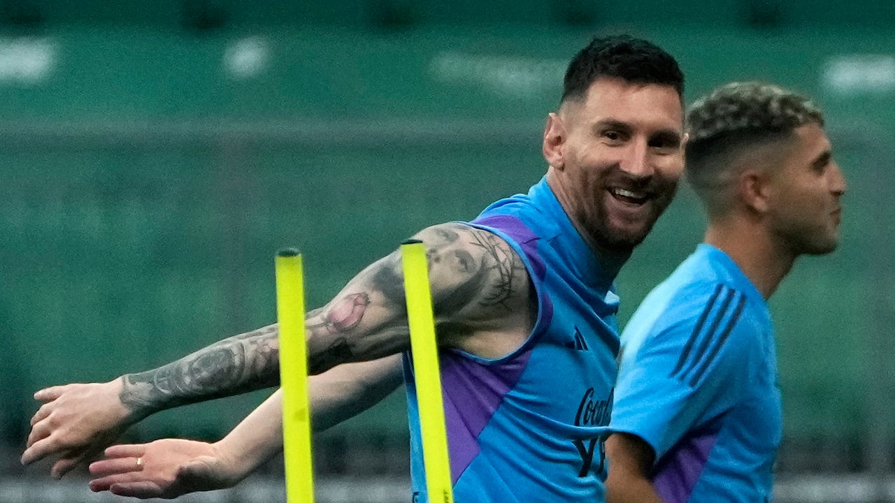 Lionel Messi reacts as he jogs with his teammates of Argentina's national soccer team as they practice one day ahead of their friendly soccer match against Australia in Beijing, Wednesday, June 14, 2023. (AP Photo/Andy Wong)