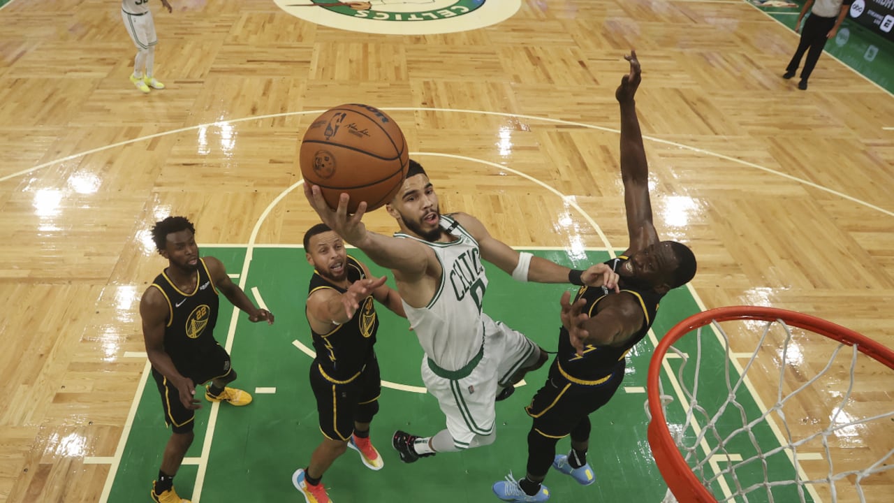 Boston Celtics forward Jayson Tatum (0) puts up a shot between Golden State Warriors' Stephen Curry and Draymond Green, right, during Game 3 of basketball's NBA Finals, Wednesday, June 8, 2022, in Boston. (Kyle Terada/Pool Photo vía AP)