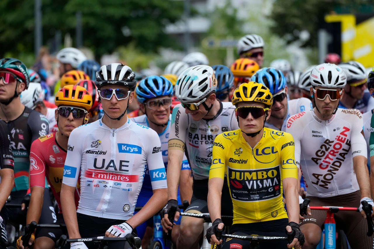 Slovenia's Tadej Pogacar, wearing the best young rider's white jersey, and Denmark's Jonas Vingegaard, wearing the overall leader's yellow jersey, wait for the start of the fourteenth stage of the Tour de France cycling race over 152 kilometers